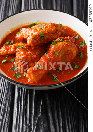 Ayam masak merah is a Malaysian traditional dish it is a casserole of chicken pieces in dried chillies sambal close-up in a bowl. Vertical 82389140