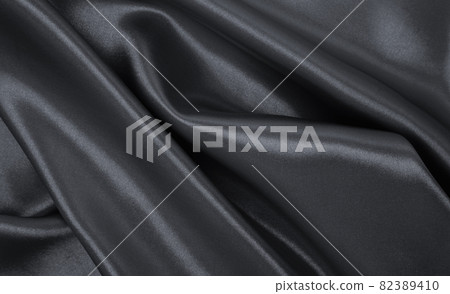 Smooth elegant dark grey silk or satin luxury cloth texture as abstract background. Luxurious background design 82389410