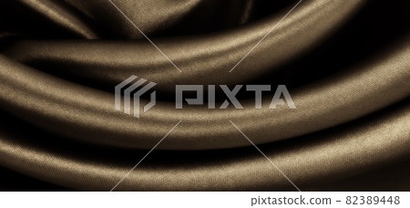Smooth elegant brown silk or satin texture as abstract background. Luxurious background design. In Sepia toned. Retro style Smooth elegant brown silk or satin texture as abstract background. Luxurious background design. In Sepia toned. Retro style 82389448