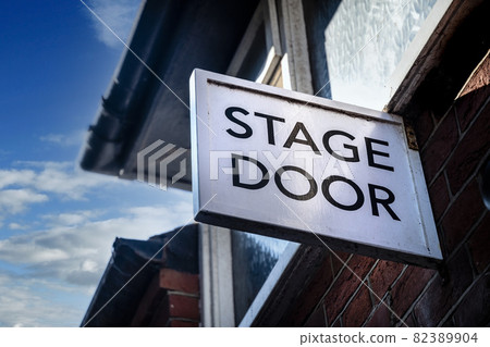 Stage door sign above entrance to theatre 82389904