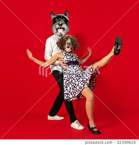 Contemporary art collage. Inspiration, idea, trendy urban magazine style. Young man and woman headed with dog's heads dancing isolated over red background 82390628