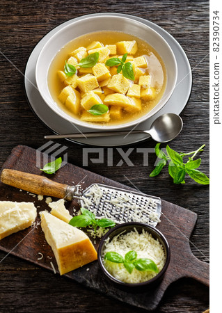 soup of chicken broth with parmesan egg dumplings soup of chicken broth with parmesan egg dumplings 82390734