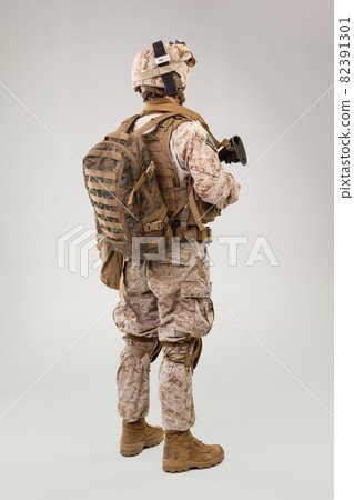 Portrait of a young American US Marine Corps soldier over grey background Portrait of a young American US Marine Corps soldier over grey background 82391301
