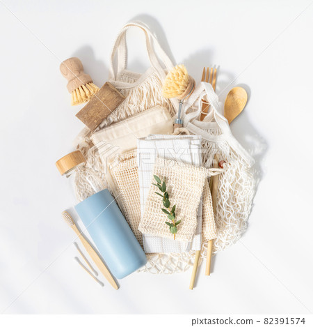 Plastic free set with cotton bags, cleaning tools, Reusable bottle, bamboo cutlery and toothbrushes top view on white background 82391574