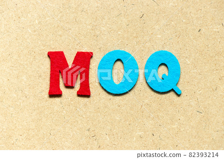 Color cloth alphabet letter in word MOQ (Abbreviation of Minimum Order Quantity) on wood background 82393214