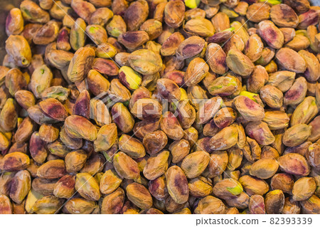 Background made of mixed nuts. Healthy snack and food. Salted and spicy pistachios, cashew and almond. Top view. Assorted nuts. Background made of mixed nuts. Healthy snack and food. Salted and spicy pistachios, cashew and almond. Top view. Assorted nuts. 82393339