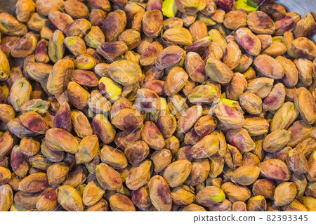 Background made of mixed nuts. Healthy snack and food. Salted and spicy pistachios, cashew and almond. Top view. Assorted nuts. Background made of mixed nuts. Healthy snack and food. Salted and spicy pistachios, cashew and almond. Top view. Assorted nuts. 82393345