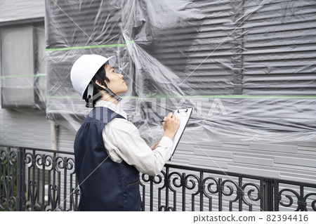 Workers inspecting cured homes Workers inspecting cured homes 82394416