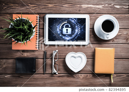 Web security and technology concept with tablet pc on wooden table 82394895