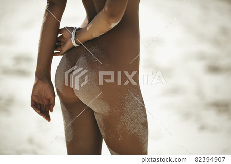 Close-up Female Tanned Buttocks on the Beach Close-up Female Tanned Buttocks on the Beach 82394907