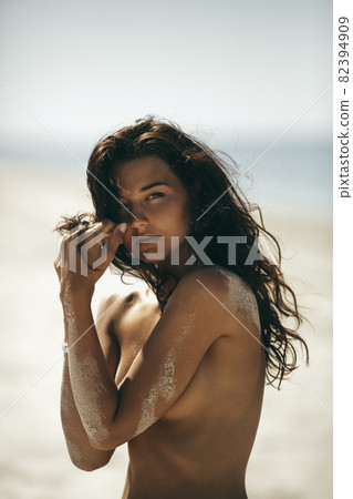 Portrait of Tanned Naked Woman on the Beach Portrait of Tanned Naked Woman on the Beach 82394909