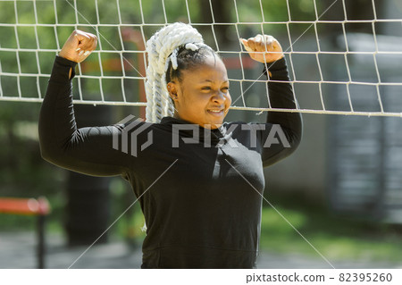 Afro-american plus size woman doing workout exercises session outdoor Afro-american plus size woman doing workout exercises session outdoor 82395260