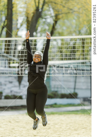 Afro-american plus size woman doing workout exercises session outdoor 82395261