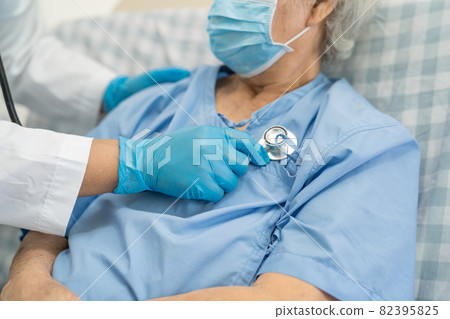 Doctor help Asian senior or elderly old lady woman patient wearing a face mask in hospital for protect safety infection and kill Covid-19 Coronavirus. Doctor help Asian senior or elderly old lady woman patient wearing a face mask in hospital for protect safety infection and kill Covid-19 Coronavirus. 82395825