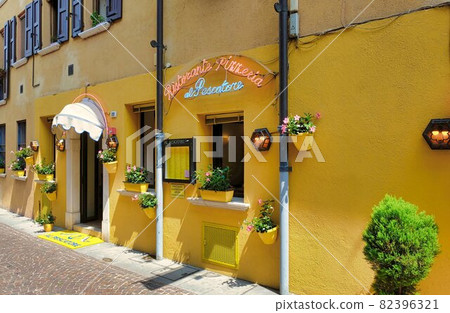 old houses on a street in riva del garda old houses on a street in riva del garda 82396321