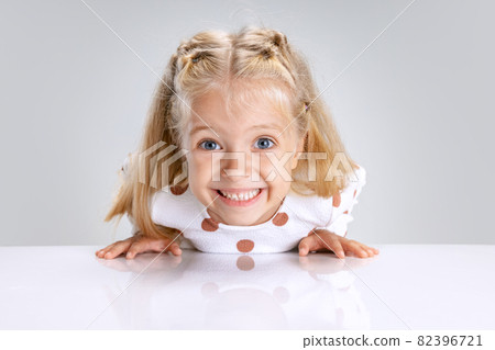 Portrait of little preschool girl posing isolated over white studio background. Excited child Portrait of little preschool girl posing isolated over white studio background. Excited child 82396721