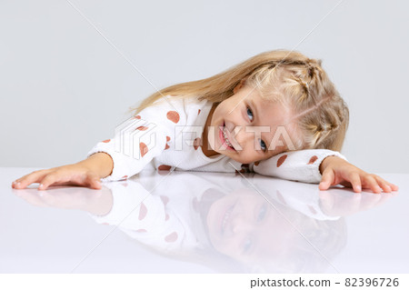 Portrait of little preschool girl, child posing isolated over white studio background. Portrait of little preschool girl, child posing isolated over white studio background. 82396726