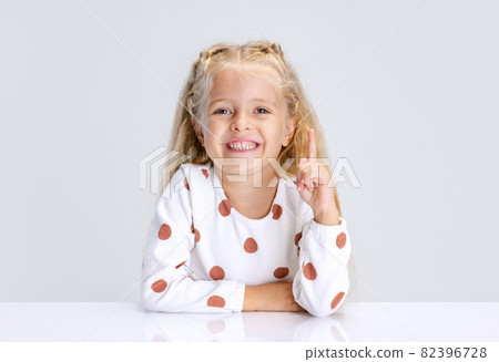 Portrait of little preschool girl, child posing isolated over white studio background. Portrait of little preschool girl, child posing isolated over white studio background. 82396728