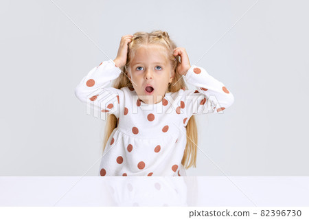 Portrait of little preschool girl, child with shocked expression isolated over white studio background. Portrait of little preschool girl, child with shocked expression isolated over white studio background. 82396730