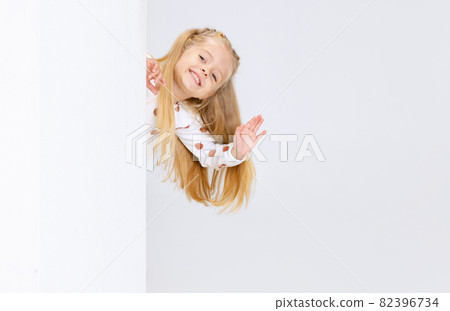 Side view portrait of little preschool girl, child waving hello isolated over white studio background. Side view portrait of little preschool girl, child waving hello isolated over white studio background. 82396734