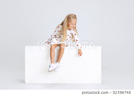 Portrait of little preschool girl pointing away isolated over white studio background. Portrait of little preschool girl pointing away isolated over white studio background. 82396748