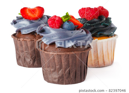 Three tasty cupcakes with cream topping isolated on white Three tasty cupcakes with cream topping isolated on white 82397046