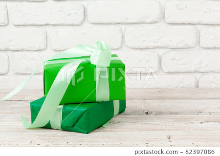 Colorful gift boxes against white brick wall background 82397086