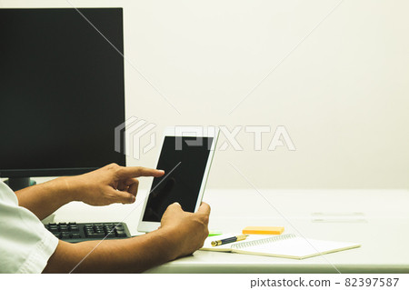 Asian Software engineer touch taplet to check information Asian Software engineer touch taplet to check information 82397587