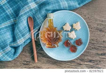 Maple syrup sugar shack restaurant cabin in Quebec, Canada. Typical local food of spring season, bottle and candy taffy rustic table top view canadian natural product. Kitchen cooking 82397621