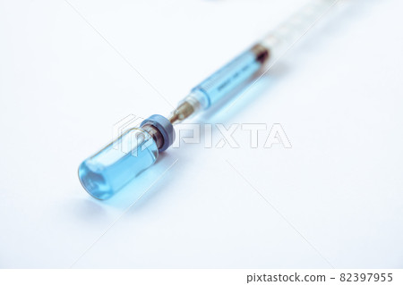 Close-up vials with vaccine and syringe for virus protection isolated on white background. Horizontal composition. 82397955