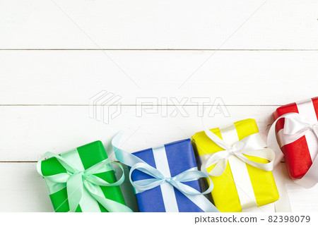 Wrapped gifts with ribbon on white wooden background top view Wrapped gifts with ribbon on white wooden background top view 82398079