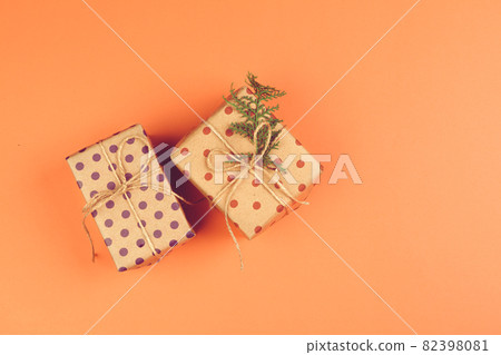 Present with a bow on orange background 82398081