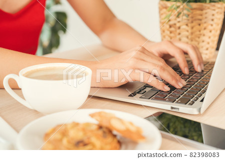 Young woman working in office using computer, sitting at desk Young woman working in office using computer, sitting at desk 82398083