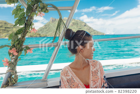French Polynesia cruise ship excursion travel woman going on motu picnic on Huahine summer vacation adventure 82398220