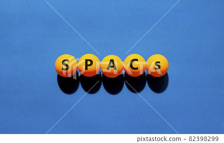 SPACs symbol. Table tennis balls with words 'SPACs, special purpose acquisition companies' on beautiful blue background, copy space. Business and SPACs, special purpose acquisition companies concept. 82398299