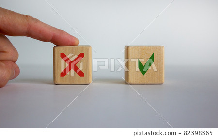 Hand making a choice between two cubes with Yes and No on neutral background. Concept of choice. Beautiful white background. 82398365