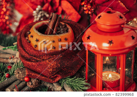 Christmas hot mulled wine with kind of spices in orange with decorations as background Christmas hot mulled wine with kind of spices in orange with decorations as background 82399968