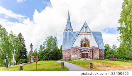 Old church kirk Raislya designed by architect Joseph Stenback in 1912 in style of Finnish national romanticism, northern variety of Art Nouveau in sunny summer day. Melnikovo, Leningrad region, Russia 82400803