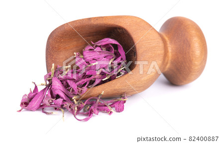 Dried Echinacea flowers in wooden scoop, isolated on white background. Petals of Echinacea purpurea. Medicinal herbs. 82400887