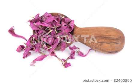 Dried Echinacea flowers in wooden spoon, isolated on white background. Petals of Echinacea purpurea. Medicinal herbs. 82400890
