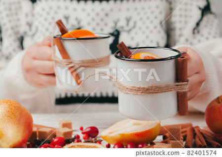 Hot muilled wine in woman's hands close up Hot muilled wine in woman's hands close up 82401574
