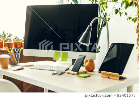 Office or home workspace. Computer monitor with black screen on office table with supplies 82401575