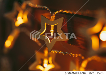 Beautiful bokeh light of star shaped garland in the dark Beautiful bokeh light of star shaped garland in the dark 82401576
