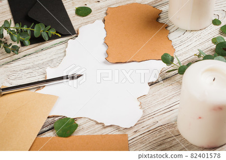 Vintage style composition with weathered paper and quill pen on wooden table close up Vintage style composition with weathered paper and quill pen on wooden table close up 82401578