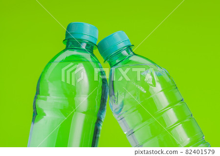 Clear and pure mineral water on a bright green background Clear and pure mineral water on a bright green background 82401579