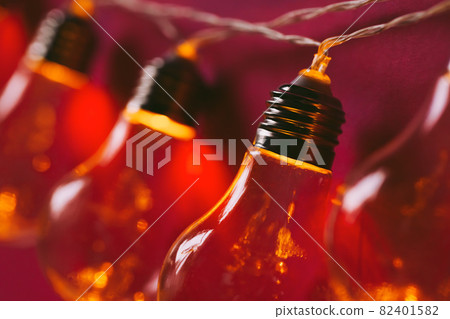 Beautiful illuminated festive light bulbs garland close up Beautiful illuminated festive light bulbs garland close up 82401582