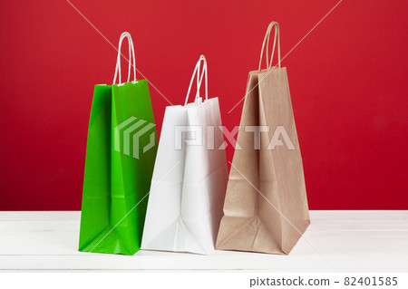 Several shopping bags with copy space on red background 82401585