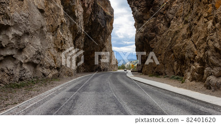 Scenic Road in the rocky canyon cliffs by Canadian Mountains. Scenic Road in the rocky canyon cliffs by Canadian Mountains. 82401620