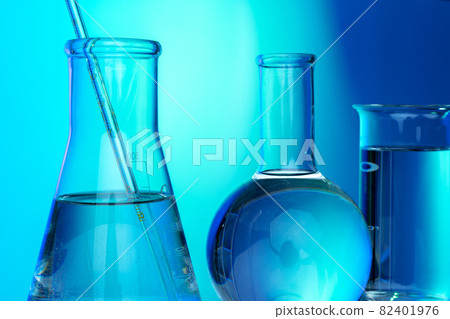 Row of test tubes with liquids on blue and green toned background Row of test tubes with liquids on blue and green toned background 82401976