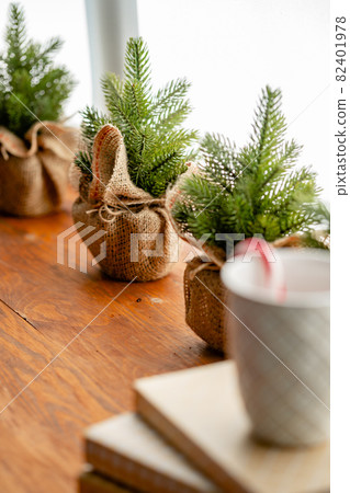 Christmas cane in a white cup on interior background 82401978